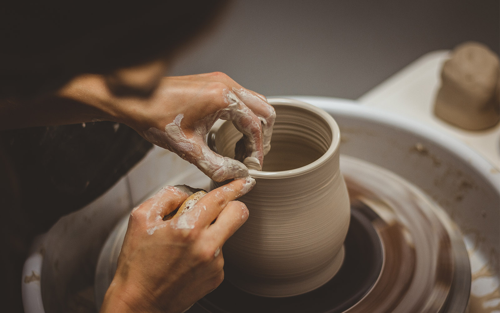 Potters hands shaping a bowl out of clay