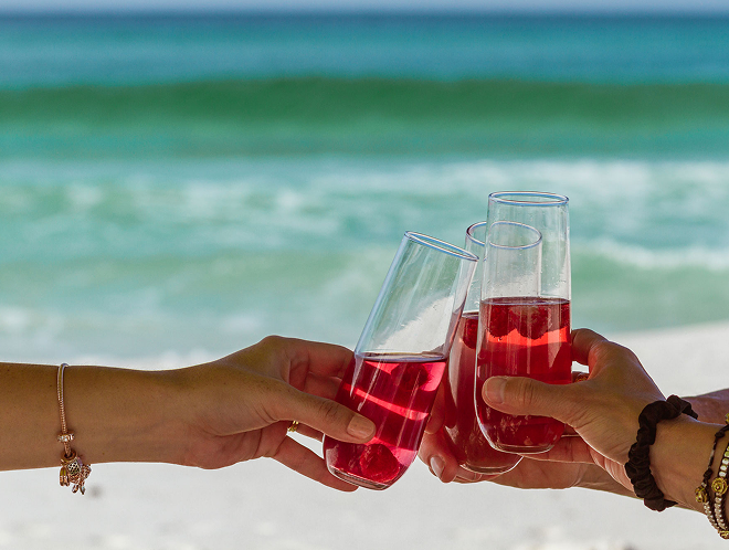 Hands touching glasses together